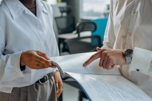 two people discussing a document